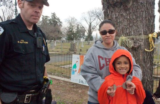 A mother is handcuffed and removed along with her daughter.