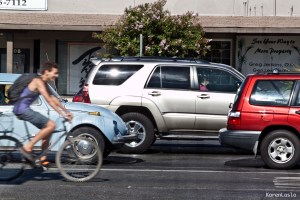 A cyclists commutes surrounded by cars because there's no safe bike lane on Mangrove Ave.